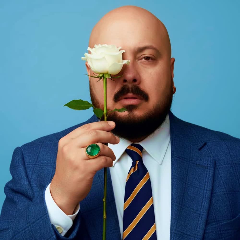 A portrait from Numinoso: a white rose held over the left eye.